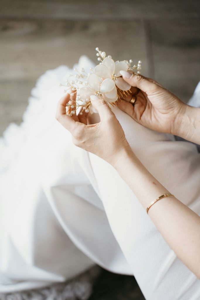 bride-holding-a-delicate-floral-hair-accessory-hrf-niefrww
